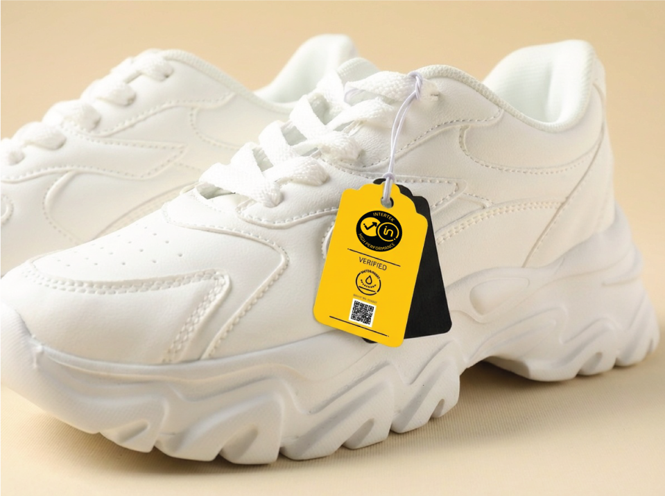 A pair of white shoes with Intertek High-Performance Mark label