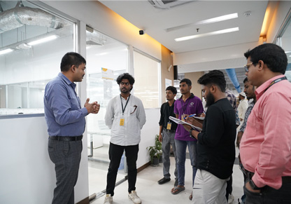 An Intertek colleague addresses a small group of university students. 