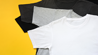 Black, white and grey t-shirts on a yellow background