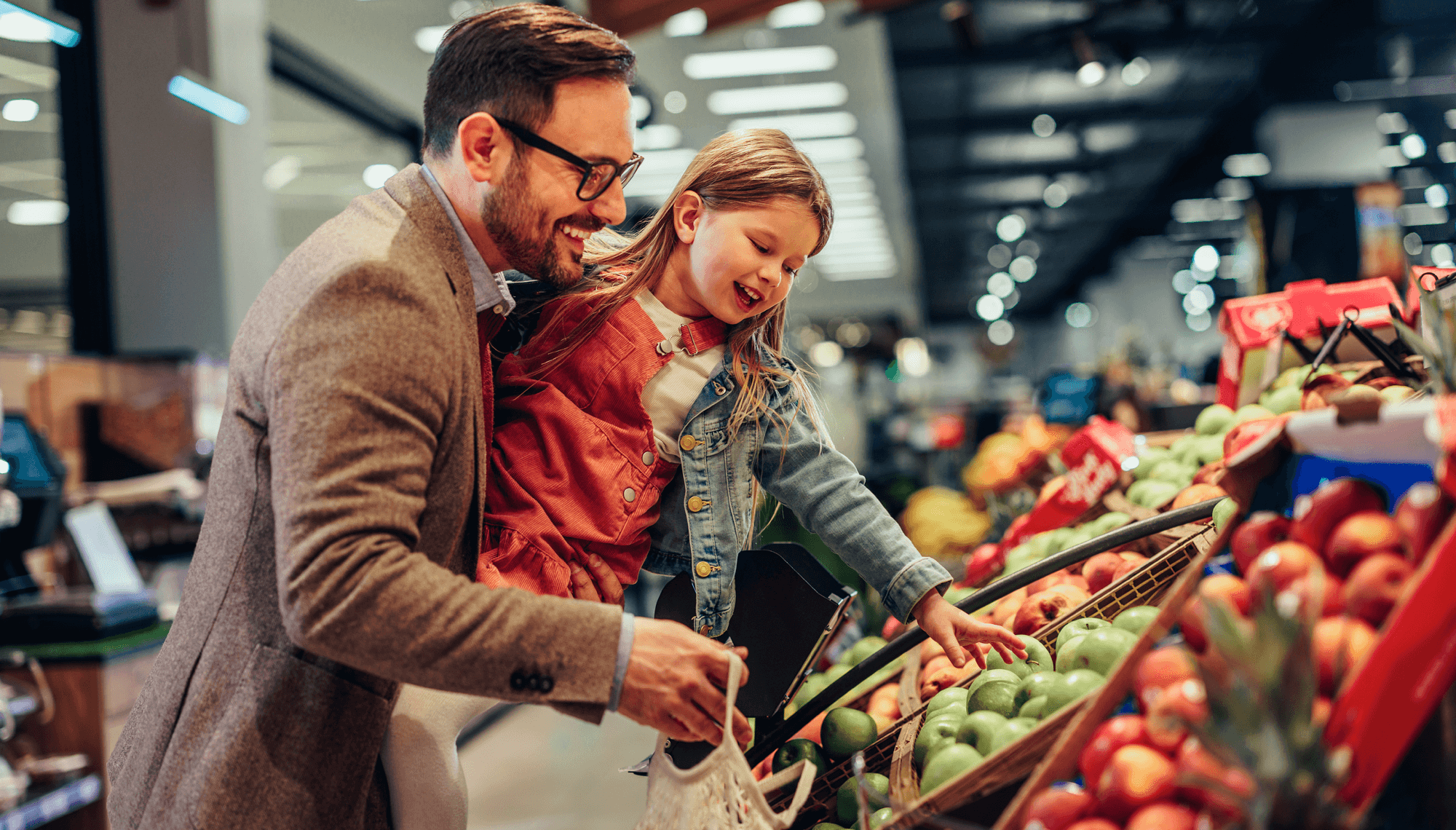 Father and daughter shopping for fresh food at grocery store