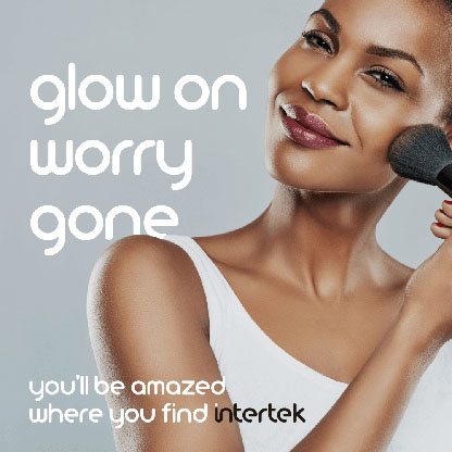 A woman applying makeup to herself with a brush